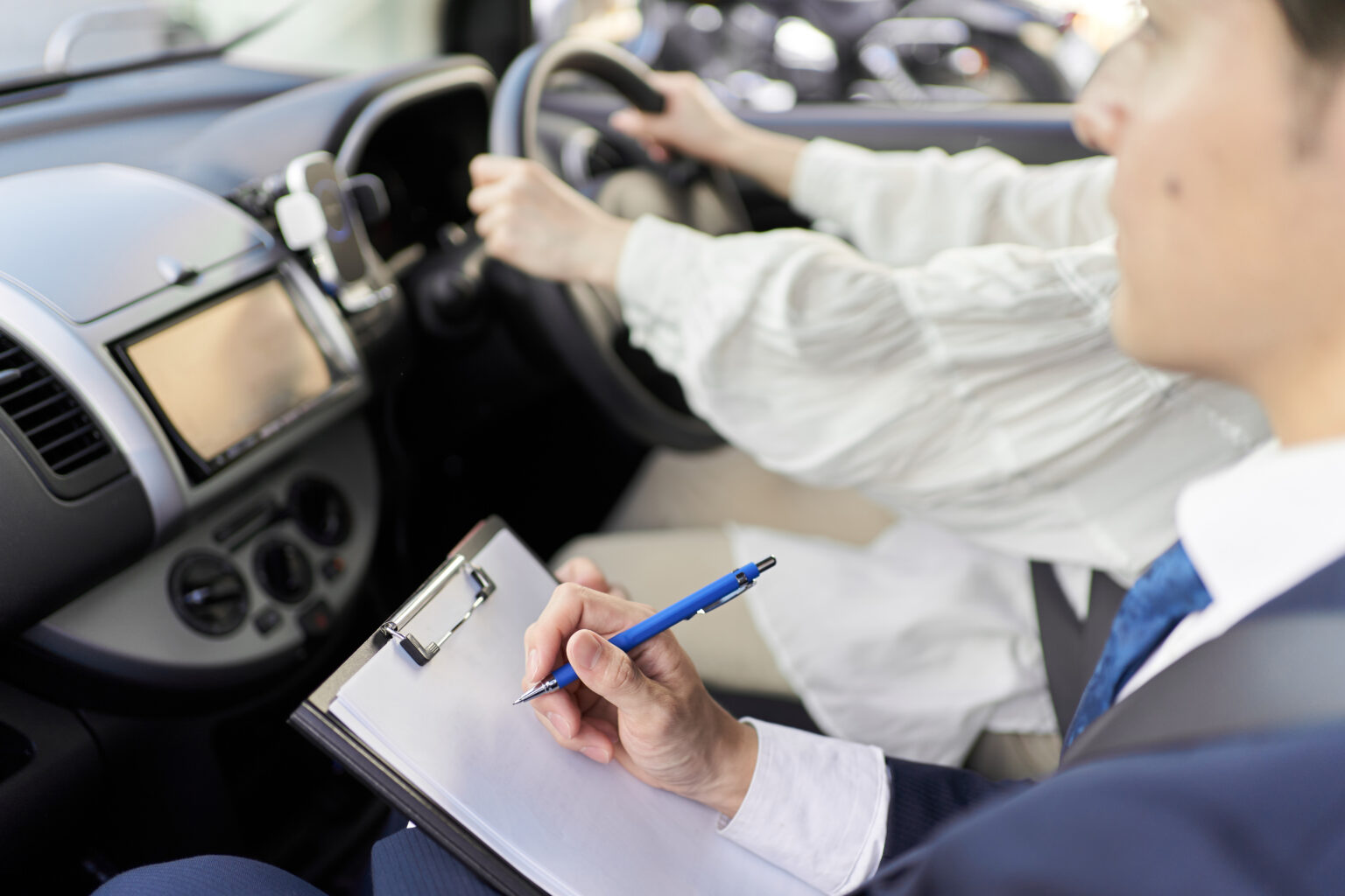 Male instructor teaching car driving