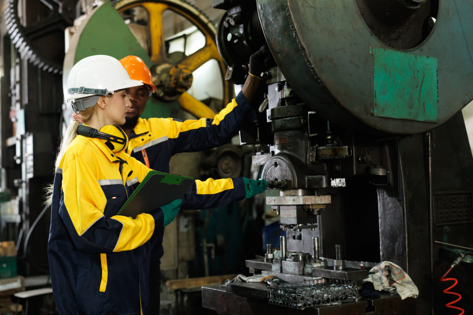 professional engineer team inspecting service machine in heavy industry factory